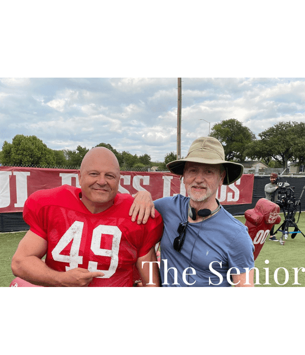 Two men posing for a picture on the field.